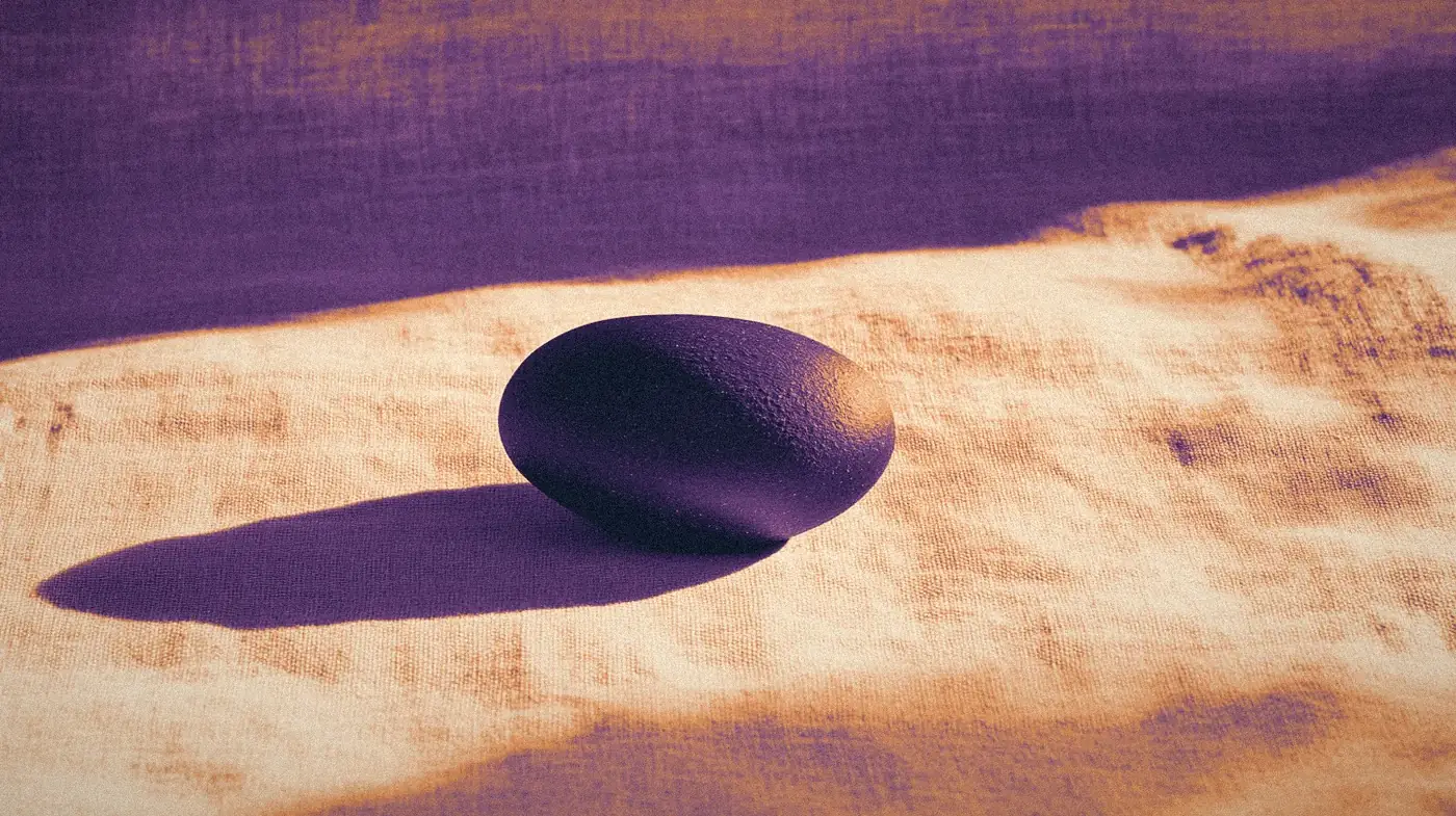 A smooth stone form on creased linen